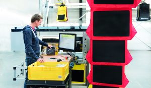 Warehouse worker scans the SKU barcode of an apparel item during order sorting process